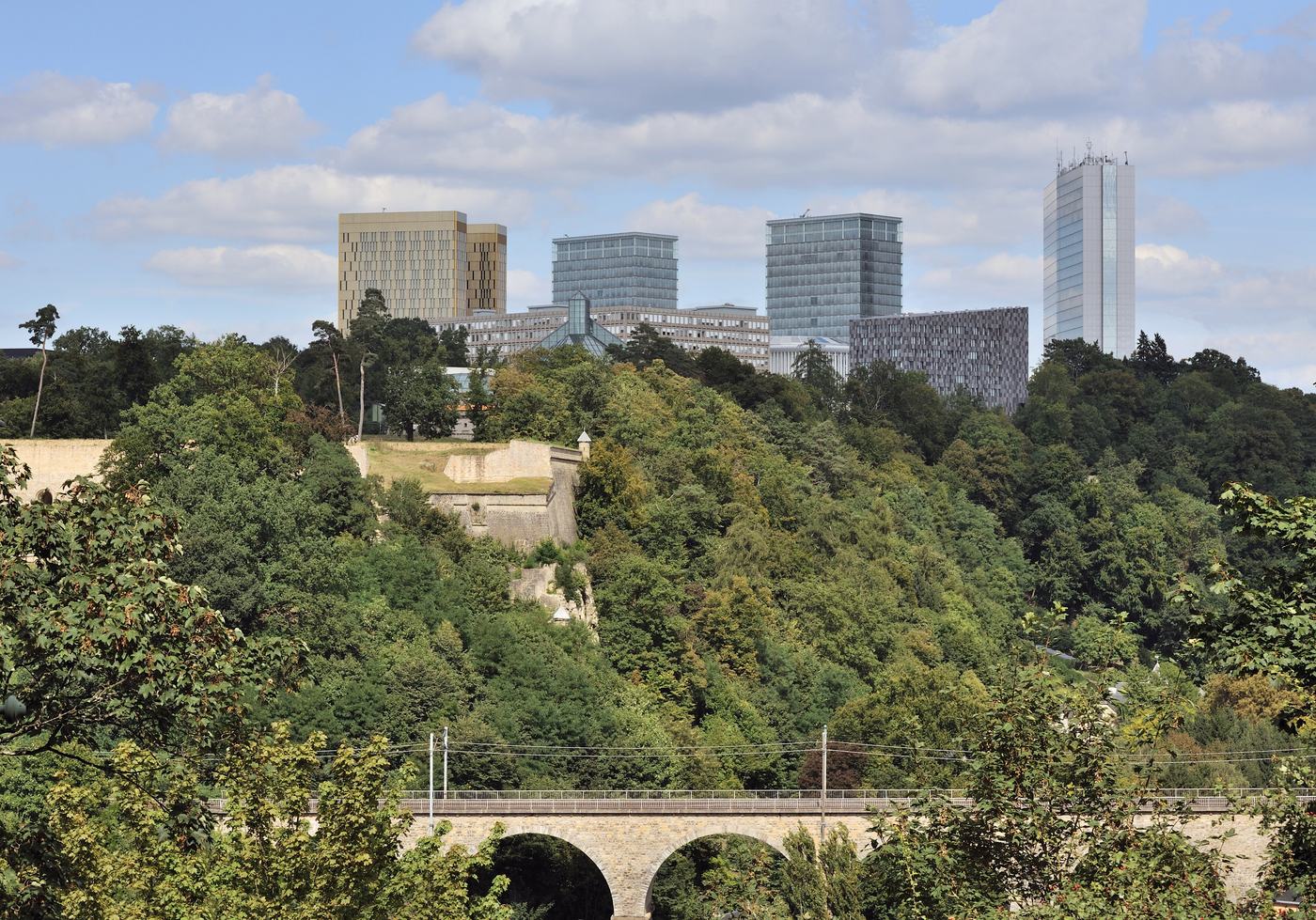 Le plateau du Kirchberg à Luxembourg-Ville vu depuis le Pfaffenthal, avec les tours des institutions européennes au-dessus des arbres